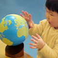 Child playing with globe