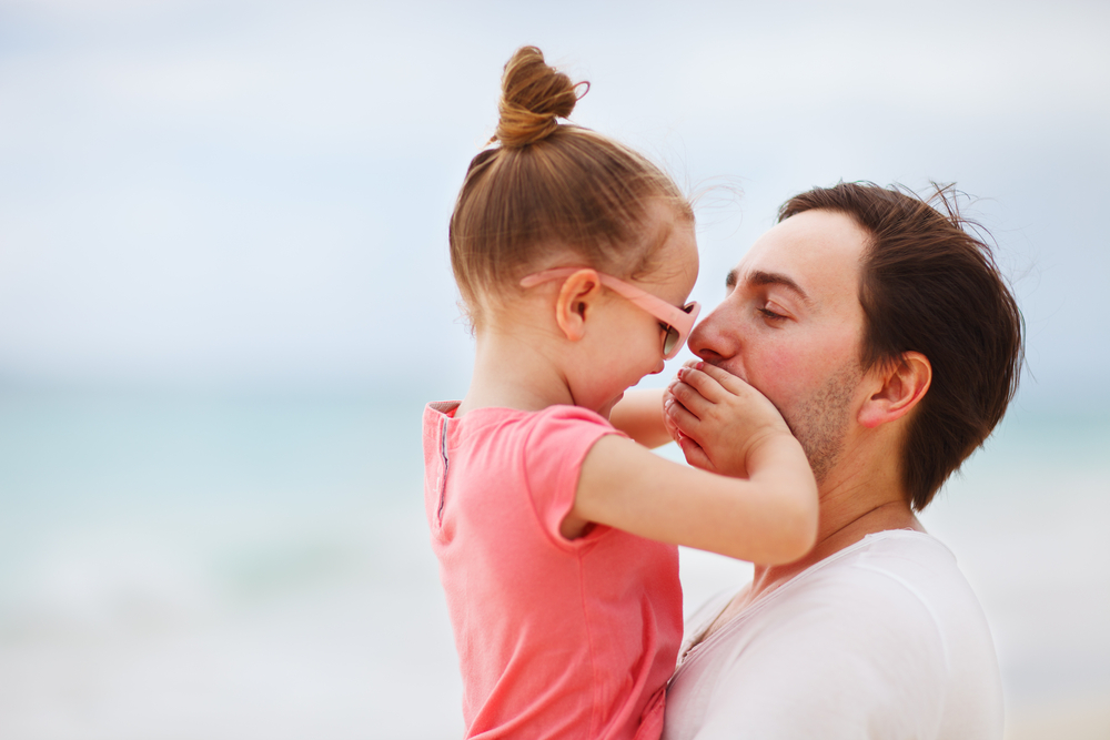 father-and-his-adorable-little-girl-on-the-beach