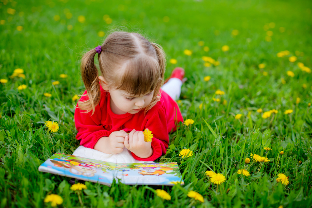 girl-lying-in-grass-reading