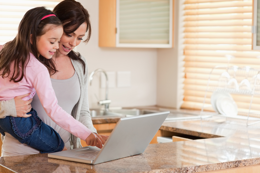mother-and-child-using-laptop-in-the-kitchen