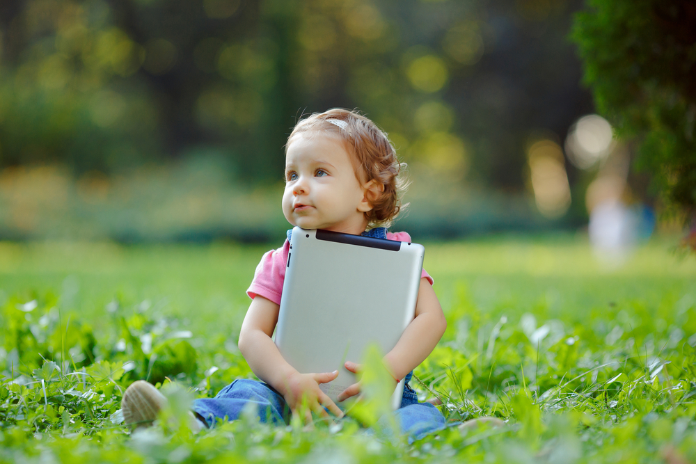 cute-baby-in-the-park-with-tablet