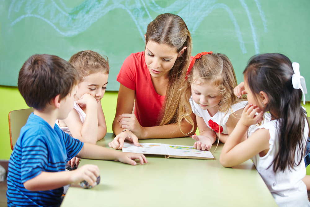 kindergarten-teacher-reading-book-aloud