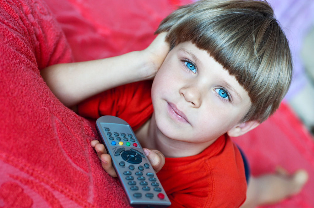 little-boy-holding-remote