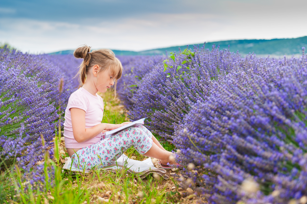 little-girl-reading-a-book-in-a-lavender-field