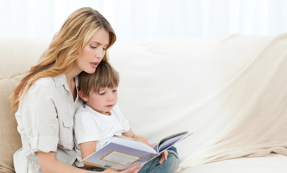 mother-with-her-son-on-sofa-reading
