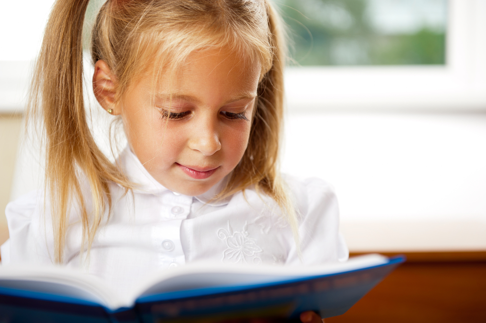 smart-girl-reading-in-class