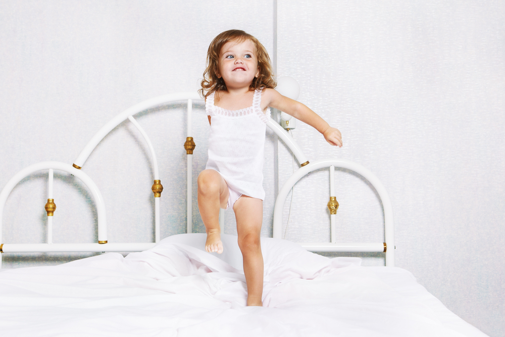 toddler-girl-dancing-in-bed