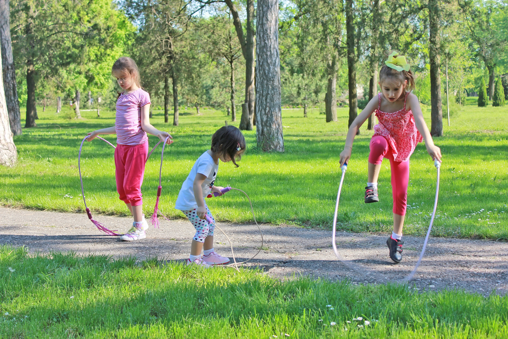 girls-skipping-rope-in-park