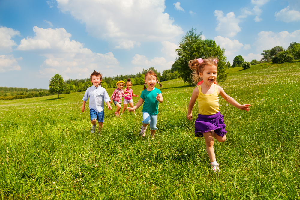running-children-in-green-field-during-summer