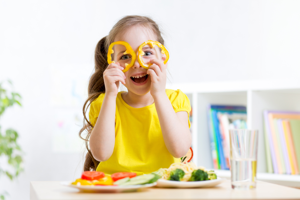 girl-eats-vegan-food-having-fun-in-kindergarten