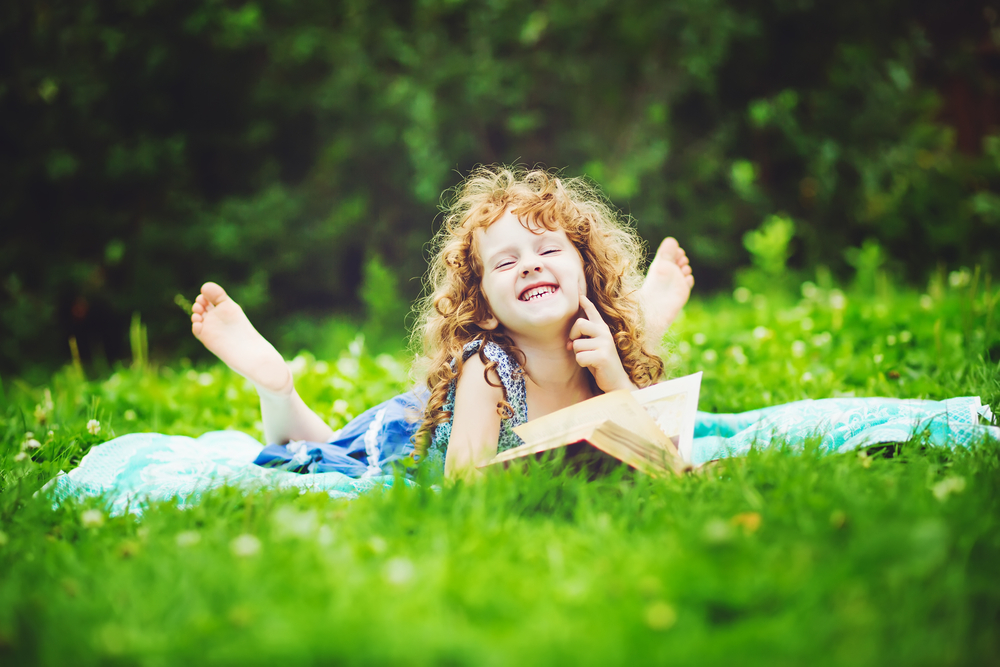 cute-little-girl-outdoors-reading