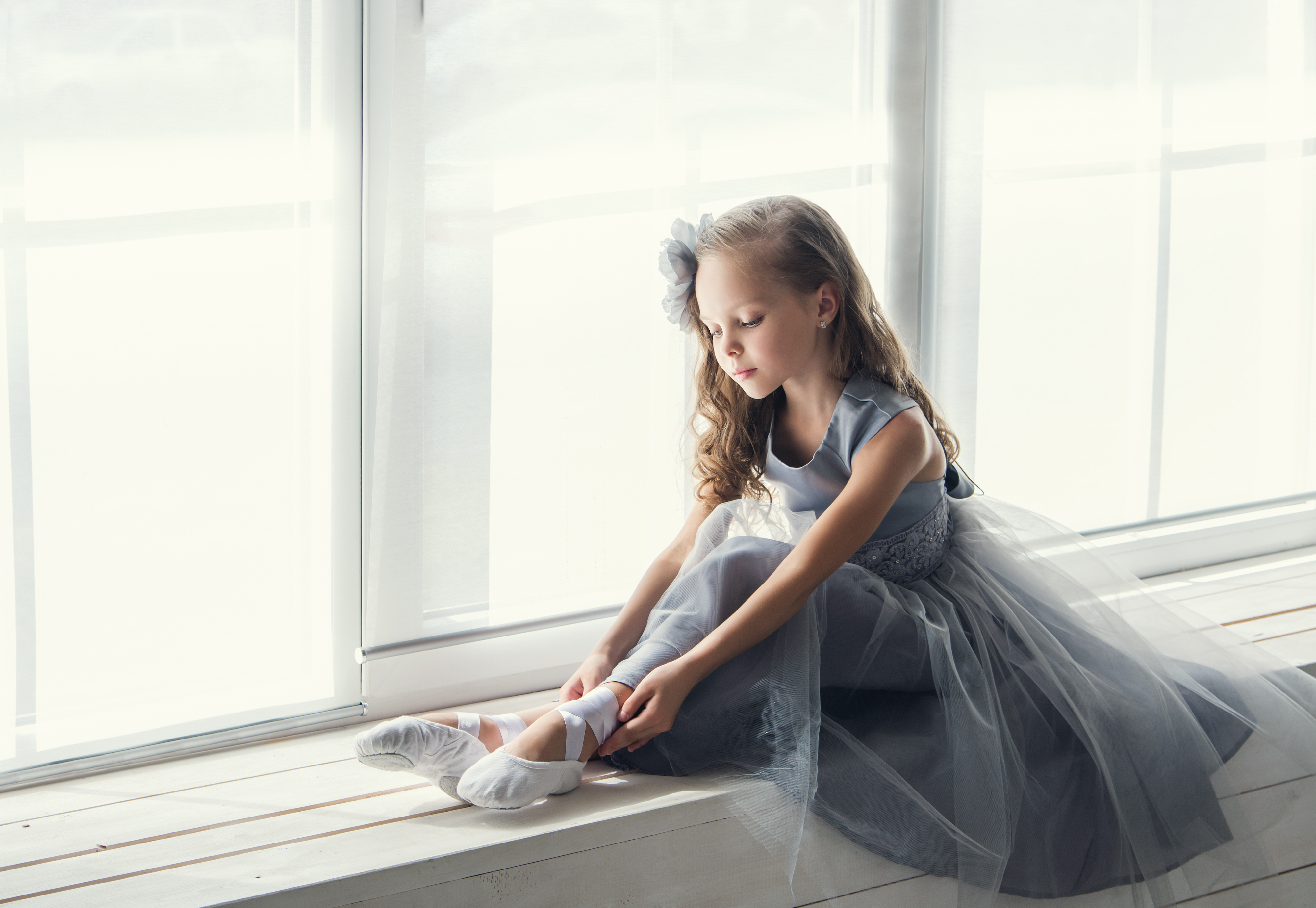 a-little-adorable-young-ballerina-in-the-interior-studio-posing-on-camera.jpg