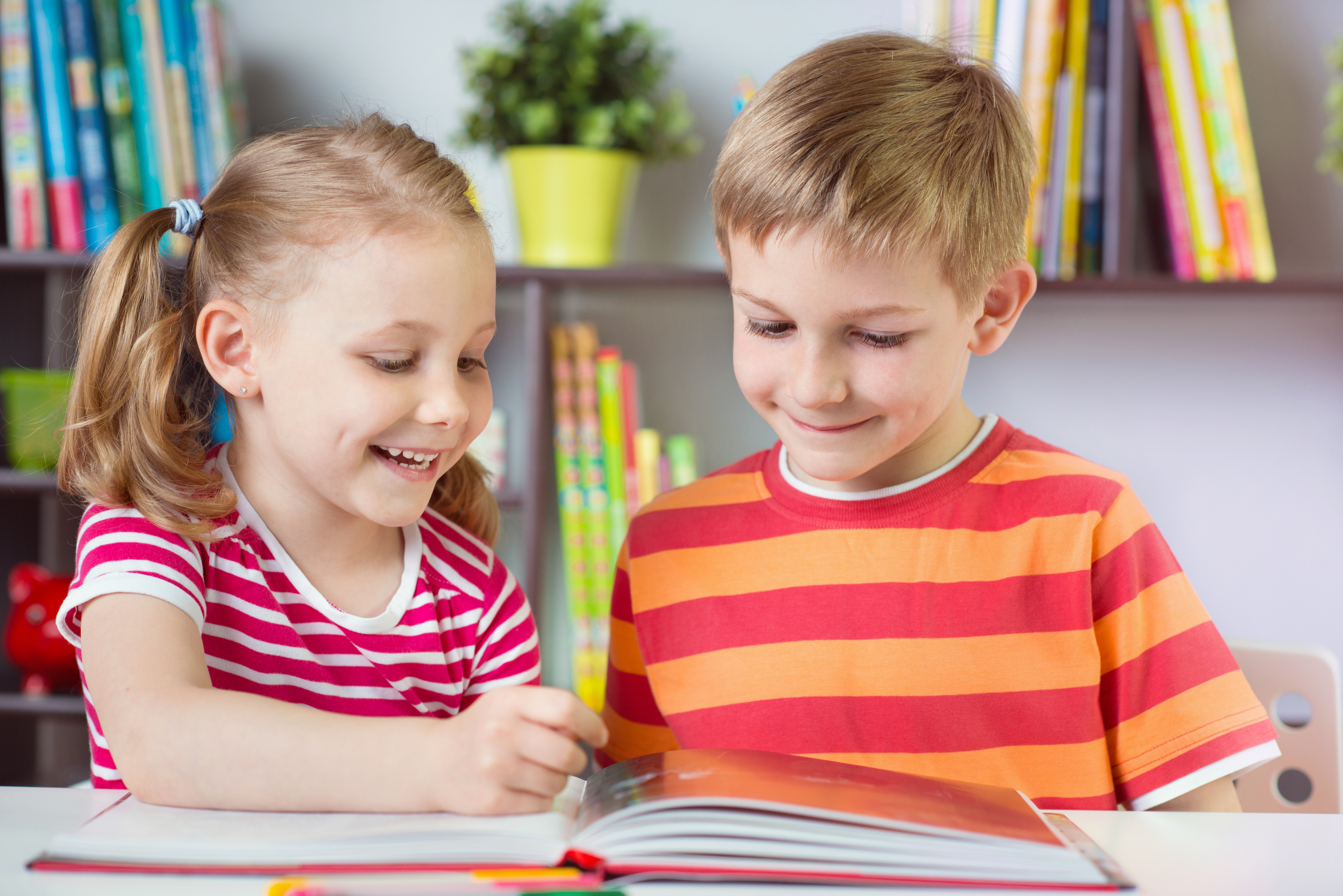 two-happy-siblings-reading-interesting-book