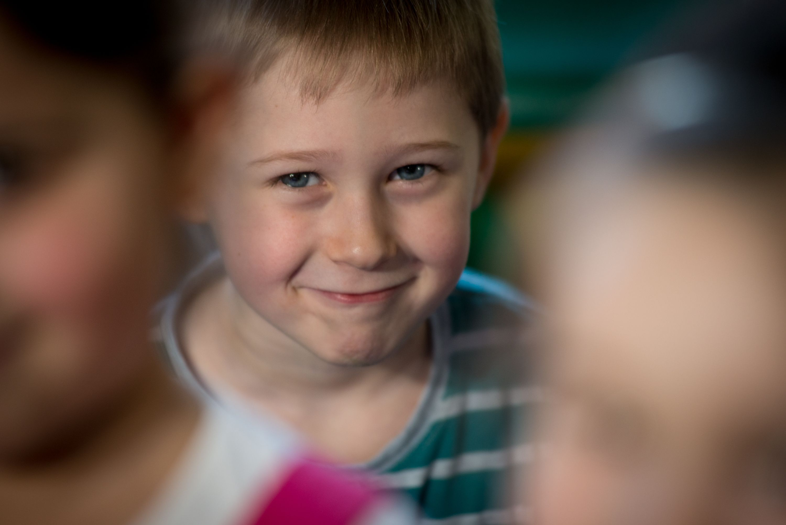 Boy looking up to the camera and smiling 