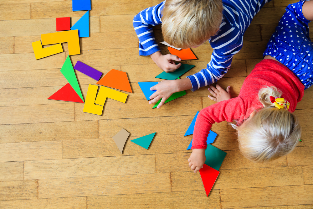 little-boy-girl-playing-geometric-shapes