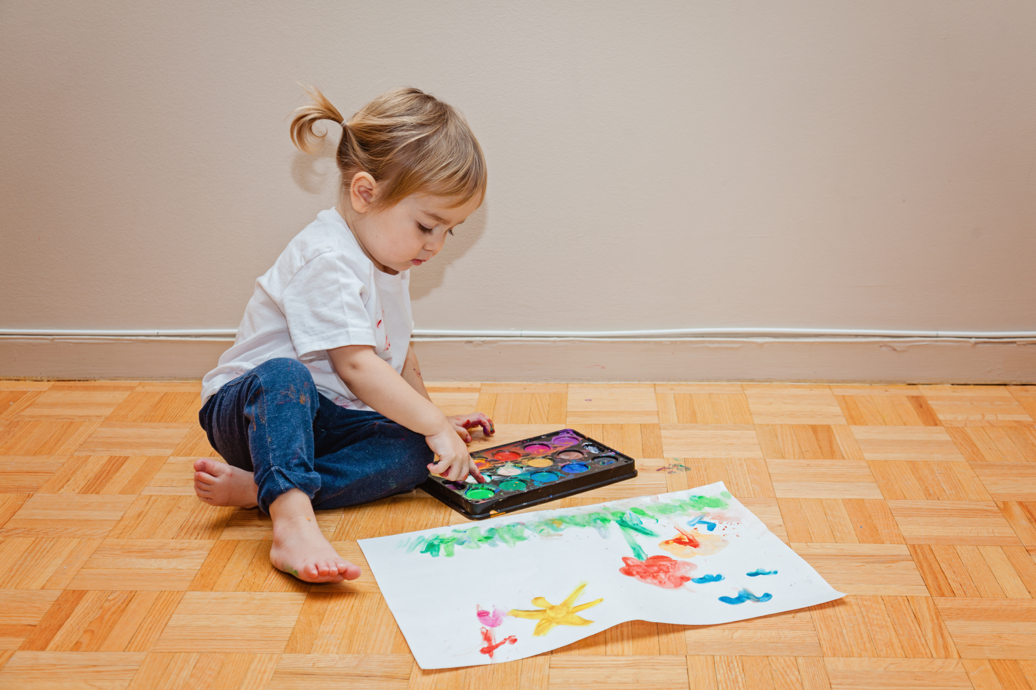 toddler-girl-trying-draw-on-the-floor