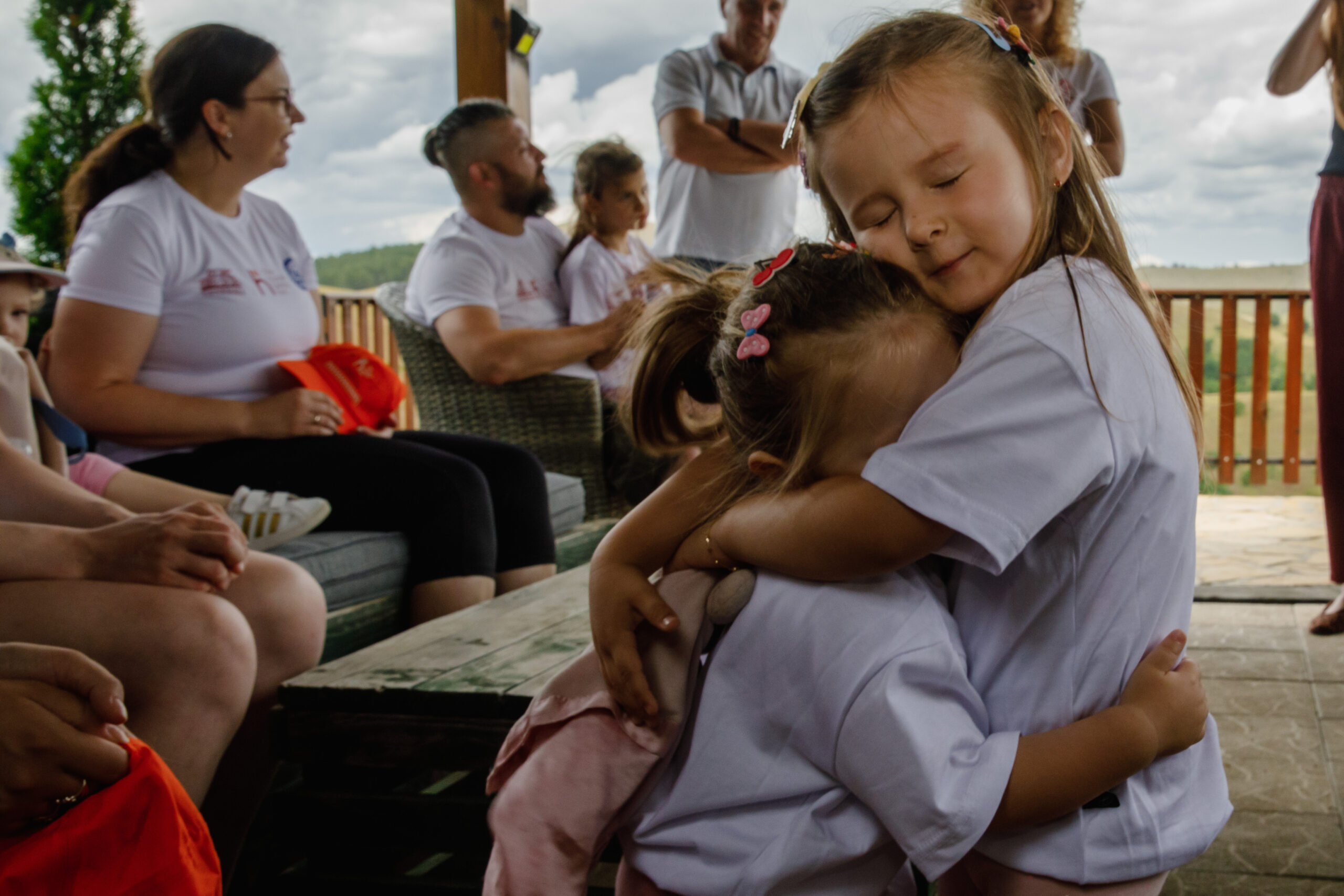 Two kids sharing a hug during activities on Zlatibor.